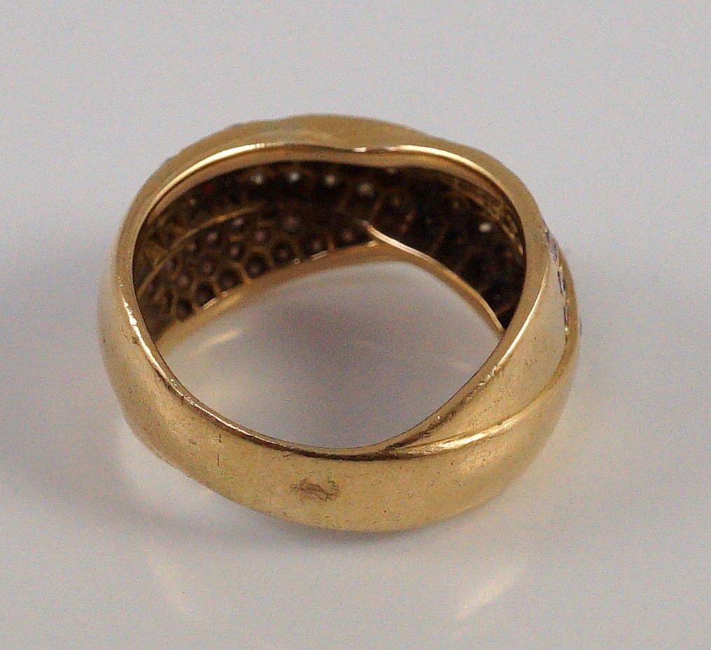 A modern gold (tests as 18ct), pink and white pave set diamond cross over ring, by Musson